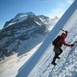 scaling an icy summit