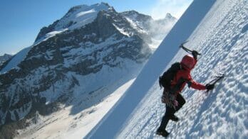 scaling an icy summit